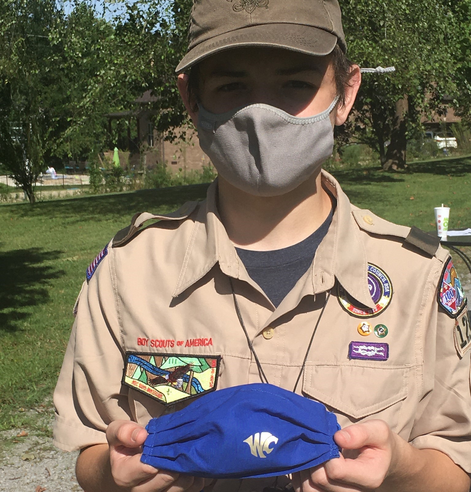A scout holding up a finished mask